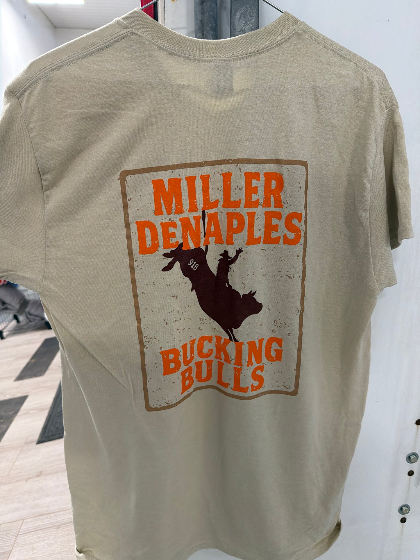 MD Bucking Bulls: Tan Short Sleeve Shirt With Brown Logo on Front